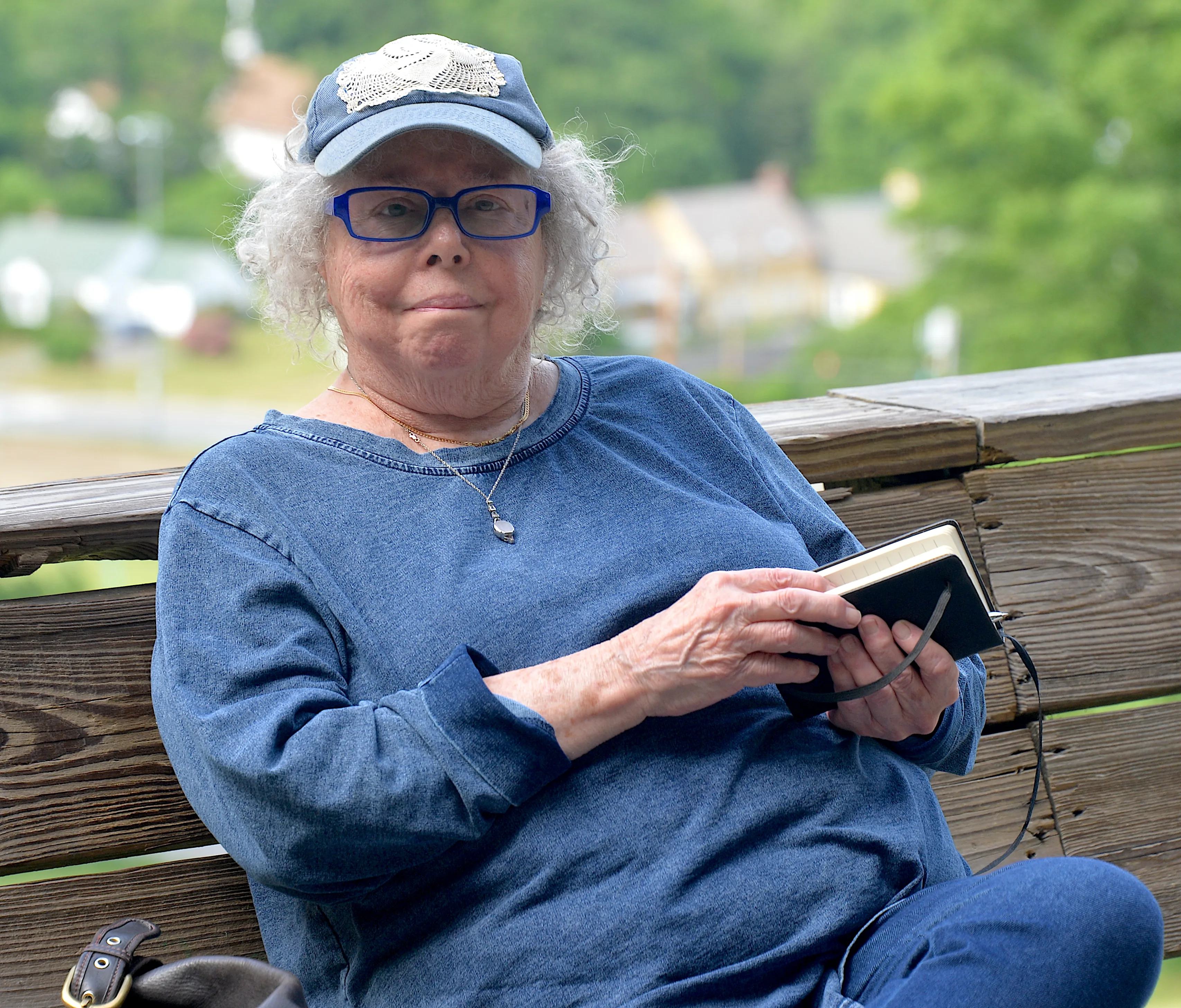Joyce Marcel seated outdoors in a blue shirt